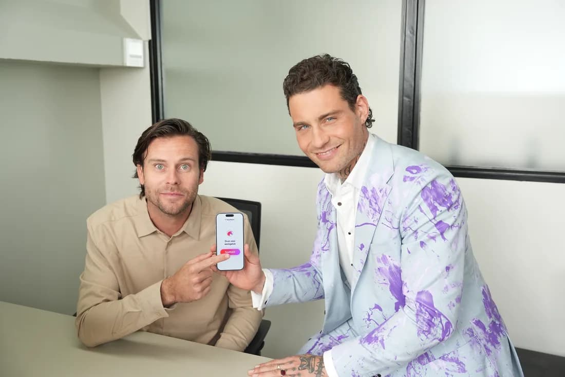 Two TotaMatch colleagues looking at the app together
